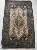 A Caucasian rug with centre medallion on a cream stylised tarantula decorated and foliate ground,