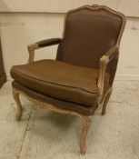 A modern "Coach House" limed beech framed armchair with brown silk upholstery in the Louis XV