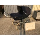 A Silver Cross Balmoral pram on chrome plated supports and spoke wheels,