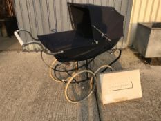 A Silver Cross Balmoral pram on chrome plated supports and spoke wheels,