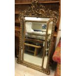 A 19th Century French giltwood and gesso framed pareclose mirror in the Louis XV taste with all