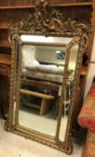 A 19th Century French giltwood and gesso framed pareclose mirror in the Louis XV taste with all