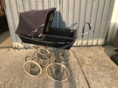 A Silver Cross pram on chrome plated supports and spoke wheels,