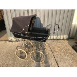 A Silver Cross pram on chrome plated supports and spoke wheels,