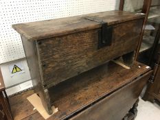 A late 18th/early 19th Century oak six plank hutch with wrought iron lock plate of hasp and staple