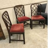 A set of three 19th Century mahogany framed dining chairs in the Chinese Chippendale taste,