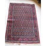 A fine Persian rug with all over leaf decoration on a red ground,