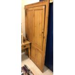 A 19th Century pine kitchen cupboard front with large twin-panelled door over a smaller door within