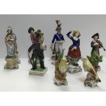 A collection of Continental porcelain figures including a pair of Canaries, 11 cm high,