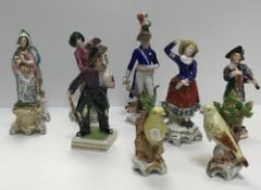 A collection of Continental porcelain figures including a pair of Canaries, 11 cm high,