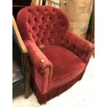 A circa 1900 red velvet upholstered buttoned tub scroll arm chair on square tapered legs 78 cm high