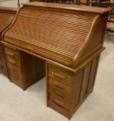 An early 20th Century oak tambour top desk,