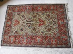 A Tabriz rug with scrolling floral and foliate decoration on a cream ground,