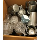 A collection of pewter tankards, glass decanters and an over-sized pocketwatch,