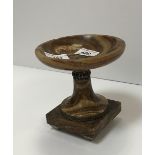 A brown onyx urn with silvered metal embellishments/banding on tapered feet, 14 cm high,