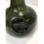 An 18th Century green glass onion shaped wine bottle with impressed seal mark to front,