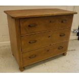 A 19th Century Continental pine commode of three long drawers, raised on turned feet,