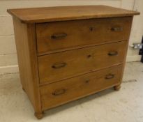 A 19th Century Continental pine commode of three long drawers, raised on turned feet,