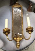 A pair of brass table lights in the French taste, decorated with putti, raised on marble socles,