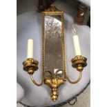 A pair of brass table lights in the French taste, decorated with putti, raised on marble socles,