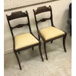 A pair of late Regency rosewood and brass inlaid bar back dining chairs on sabre legs together with