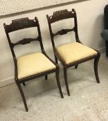 A pair of late Regency rosewood and brass inlaid bar back dining chairs on sabre legs together with