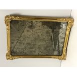 An 18th Century Vauxhall glass mirror in later gilt and gesso rectangular frame