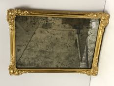 An 18th Century Vauxhall glass mirror in later gilt and gesso rectangular frame