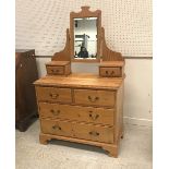 A pitch pine dressing chest in the Victorian manner with mirrored super structure over two short