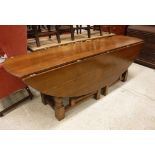 A modern cherry wood wake table of large proportions raised on a turned and ringed double gate leg