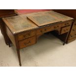An Edwardian mahogany and rosewood strung and ebonised writing table,