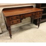 A Victorian mahogany writing table with raised back,