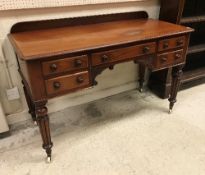 A Victorian mahogany writing table with raised back,