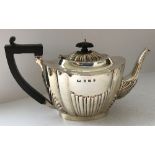 An Edwardian silver teapot with fluted decoration (by Thomas Wilkinson & Sons, Birmingham 1903),