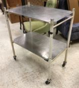 A vintage two tier medical trolley on wheels,
