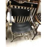 A steel framed brass embellished and leather X frame chair in the Regence taste,