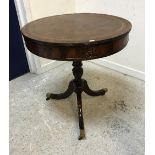 A 20th Century mahogany drum table in the George III taste,