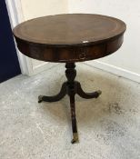 A 20th Century mahogany drum table in the George III taste,