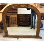 A modern pine framed dome top mantel mirror with oak leaf and acorn carved decoration,