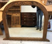 A modern pine framed dome top mantel mirror with oak leaf and acorn carved decoration,