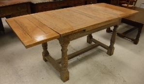 An early 20th Century oak draw leaf dining table,