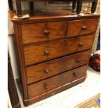 A Victorian mahogany chest of two short over three long drawers with turned knob handles raised on
