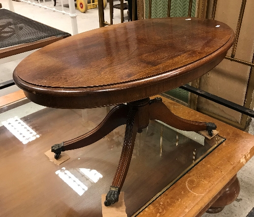 A modern reproduction mahogany oval coffee table in the Regency style,