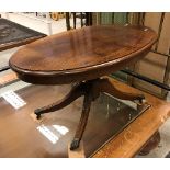 A modern reproduction mahogany oval coffee table in the Regency style,