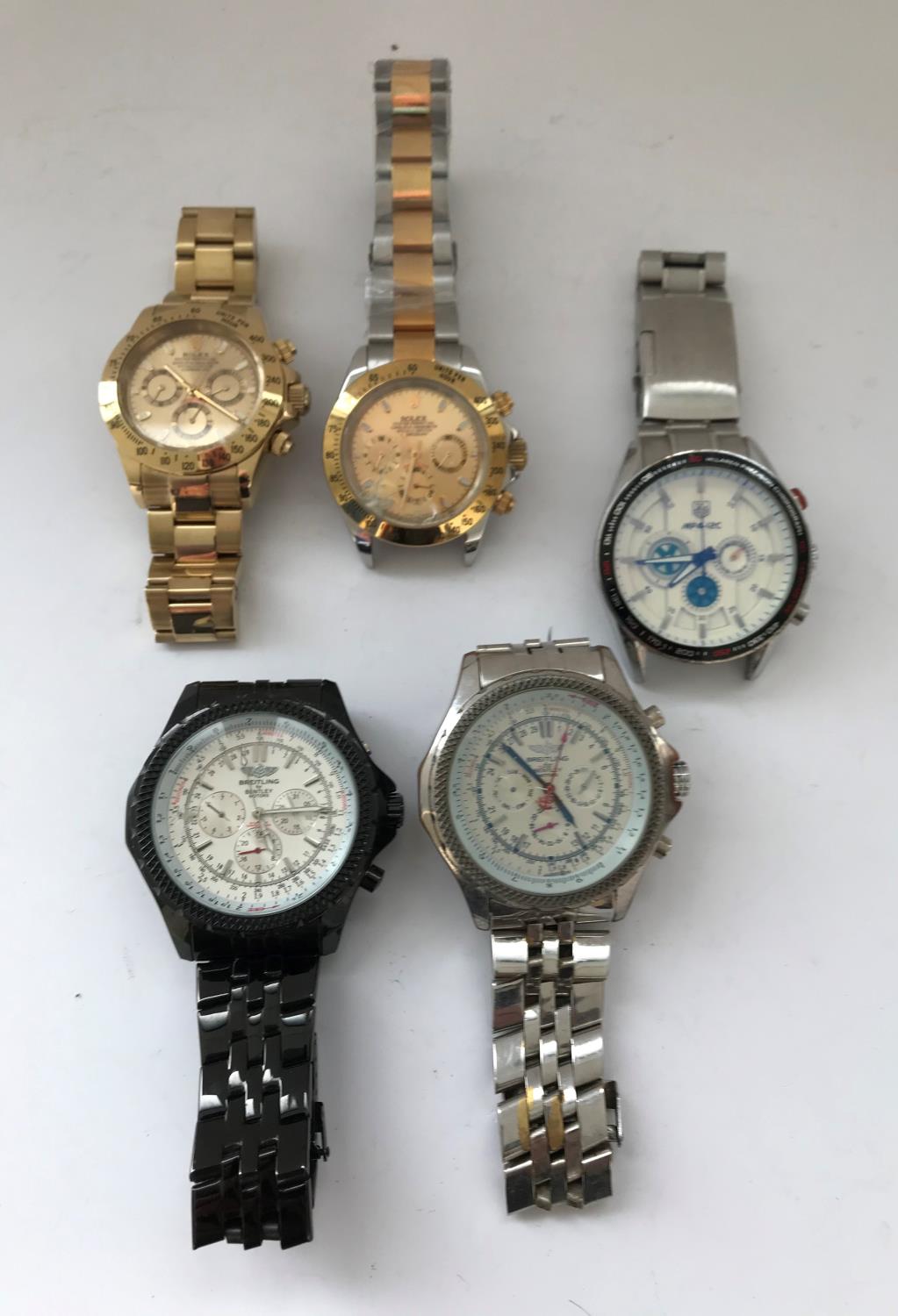 Two Rolex-style wristwatches together with Two Breitling-style wristwatches and a Tag-style