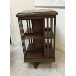 An Edwardian rosewood and inlaid revolving bookcase of typical form 47 cm square x 86.