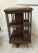 An Edwardian rosewood and inlaid revolving bookcase of typical form 47 cm square x 86.