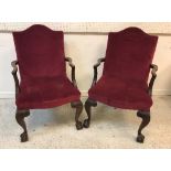A pair of early 20th Century mahogany framed elbow chairs in the George III taste,