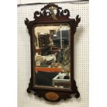 A mahogany and carved giltwood fretwork decorated wall mirror in the Georgian style with bevel