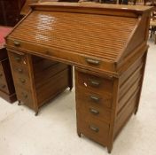 An early 20th Century oak tambour top desk,